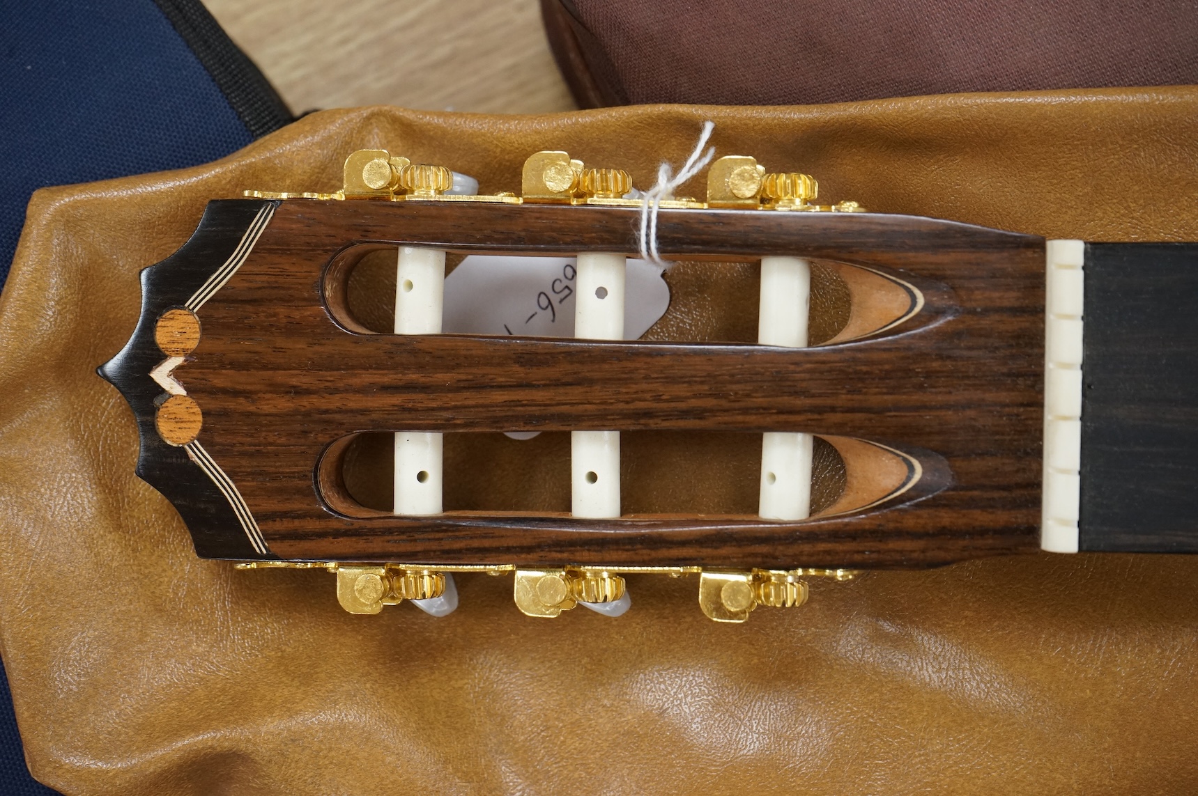 A handmade cedar, Indian Rosewood and ebony classical guitar by 'an English Luthier', with label to the inside of the body, together with a soft case.